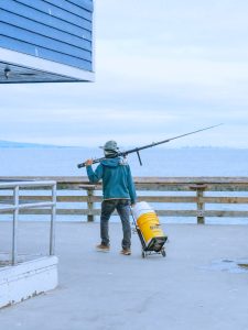 Fisherman Walking on a Pier